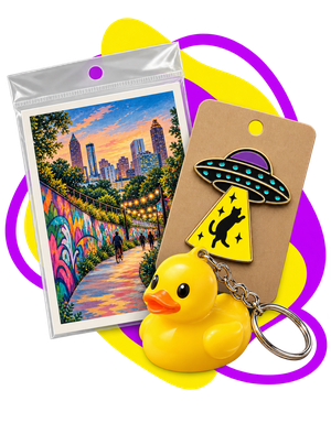 A postcard, duck keychain, and UFO tag souvenir